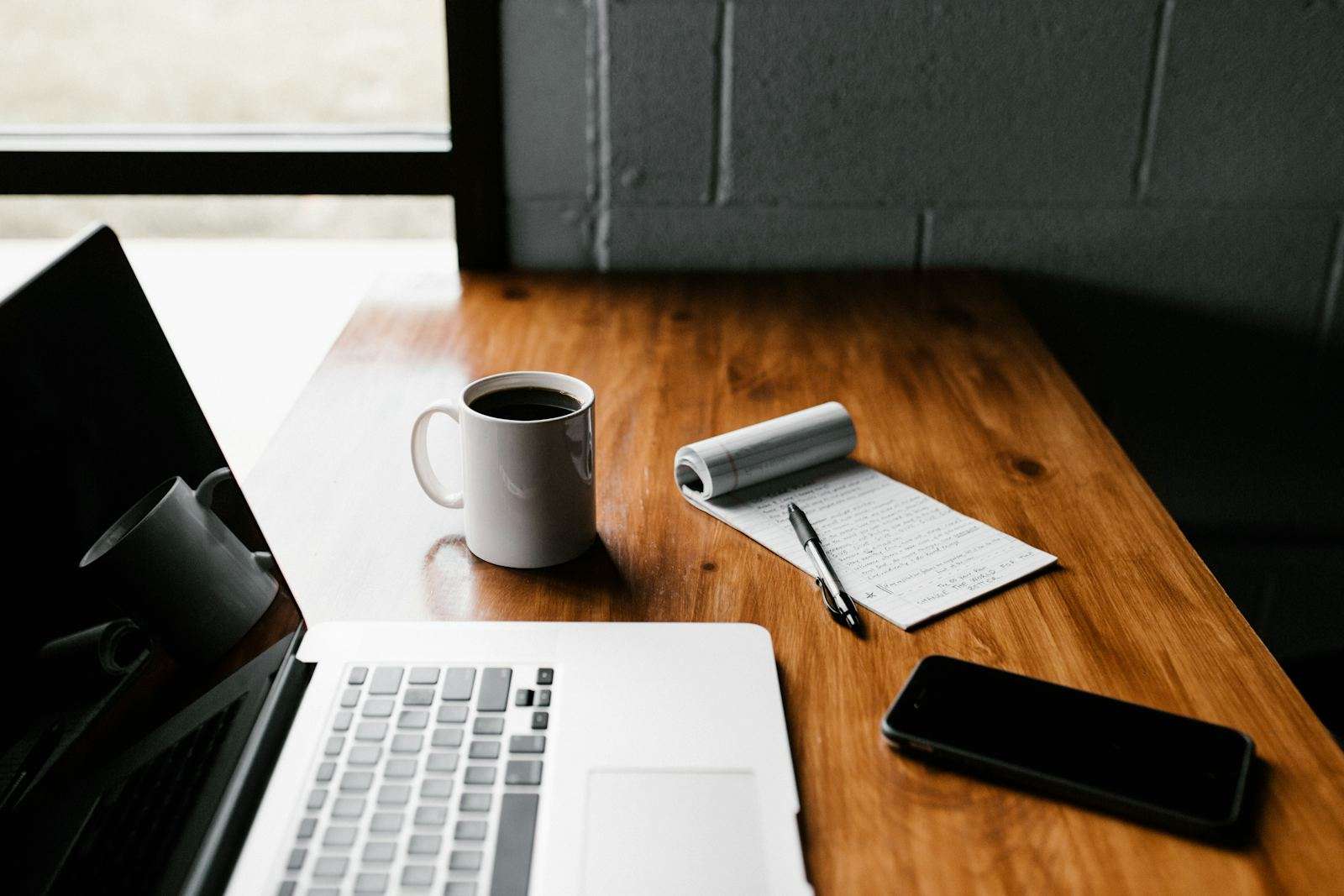 Planning a flight reservation at a laptop with coffee and notes