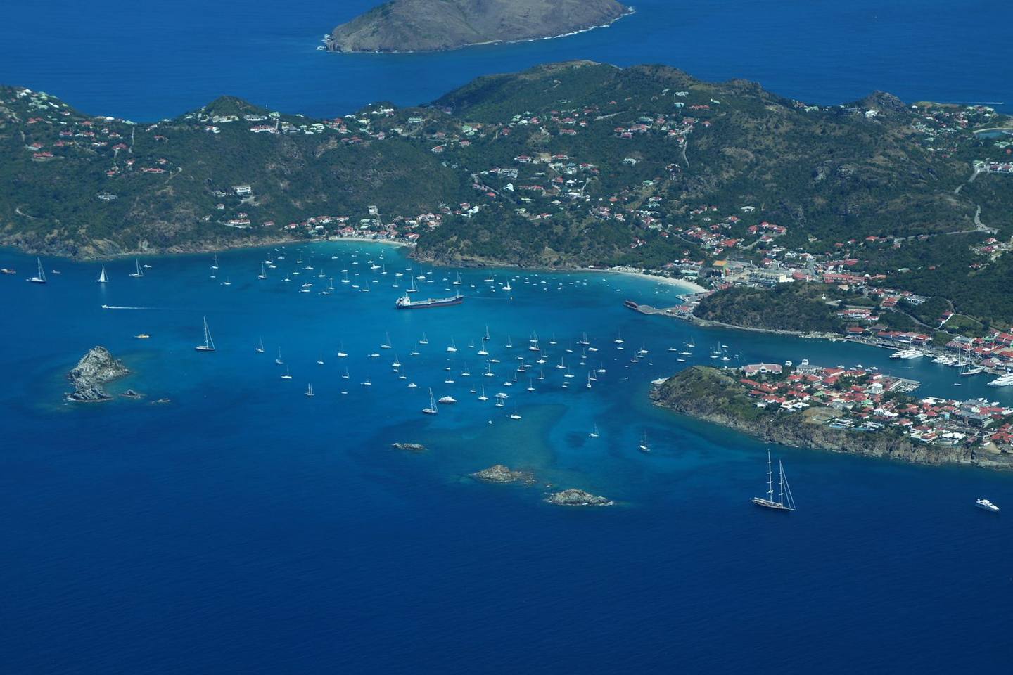Aerial view of a Caribbean harbor and green hills near St. Kitts